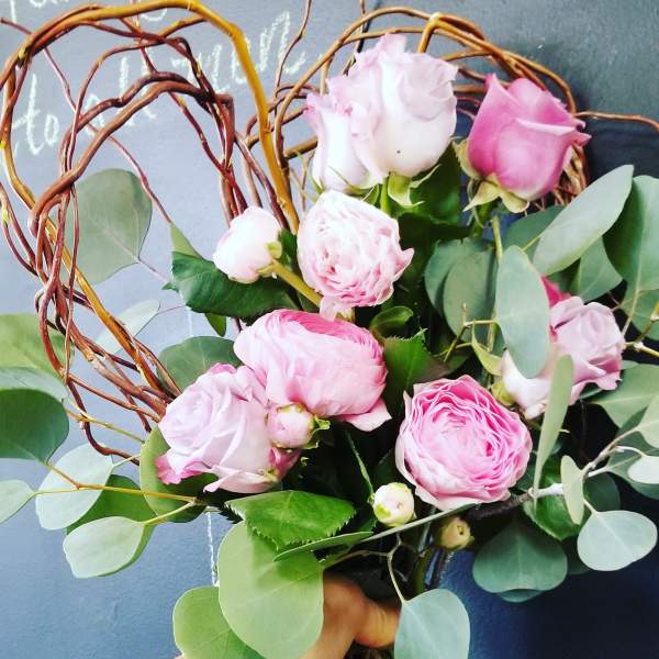 Pink roses with eucalyptus in a twig heart wreath