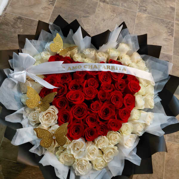 Red and white roses in the shape of a hear.