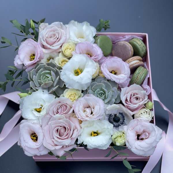 Pink and white bouquet in a pink box with macarons
