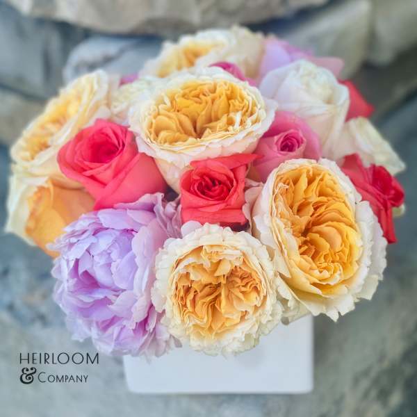 Bouquet of multicolored roses in a white box