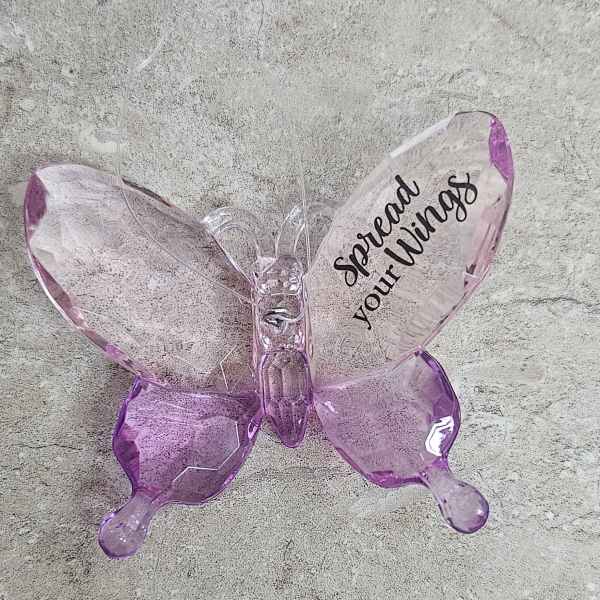 Pink translucent butterfly ornament with the words "Spread your Wings"