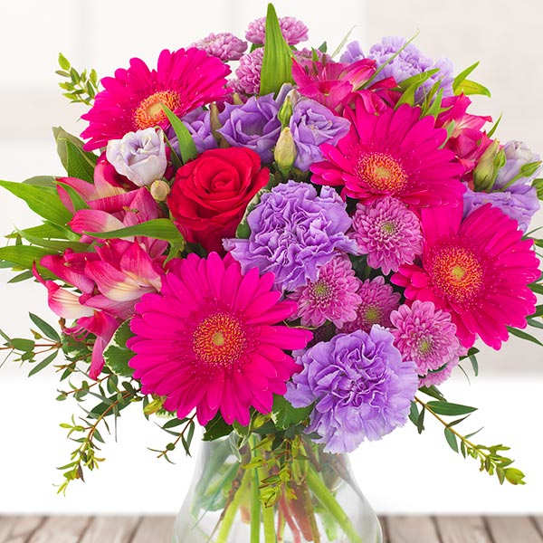 Bright mixed bouquet in a clear glass vase