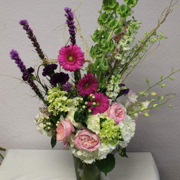 Tall mixed bouquet in a glass vase with pink and white flowers