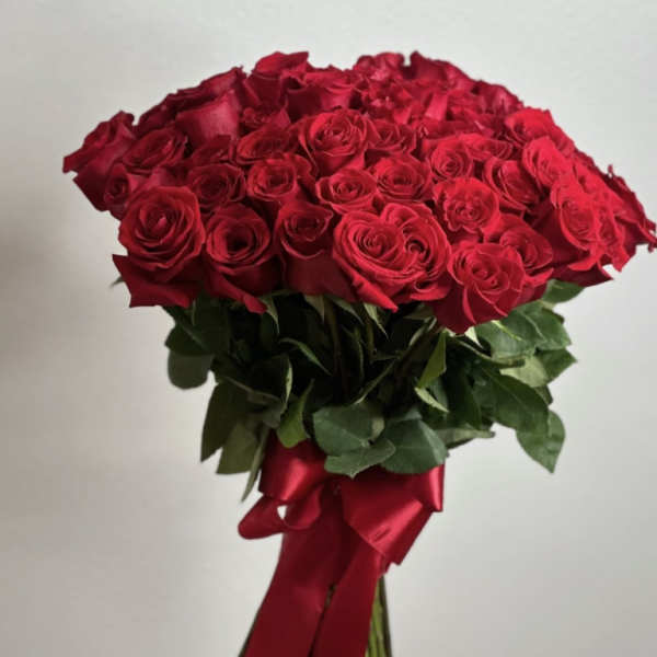 Bouquet of red roses tied with a red satin ribbon