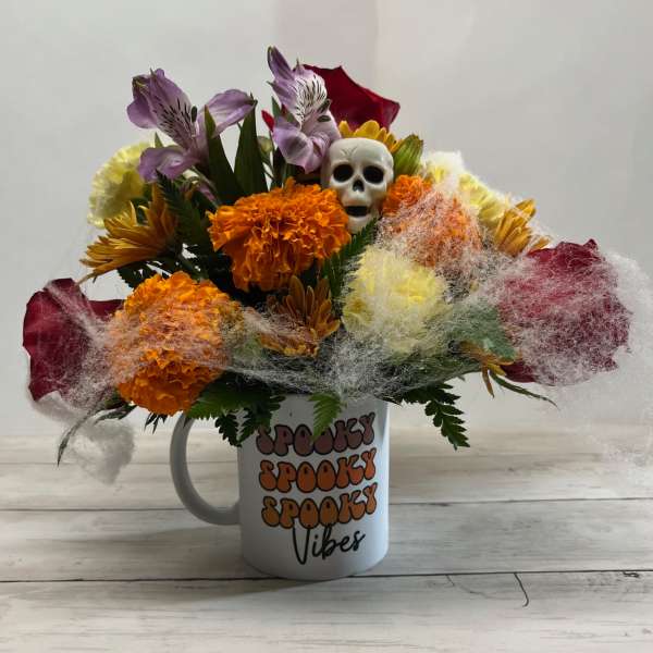 Halloween bouquet in a mug with a skull and colorful flowers