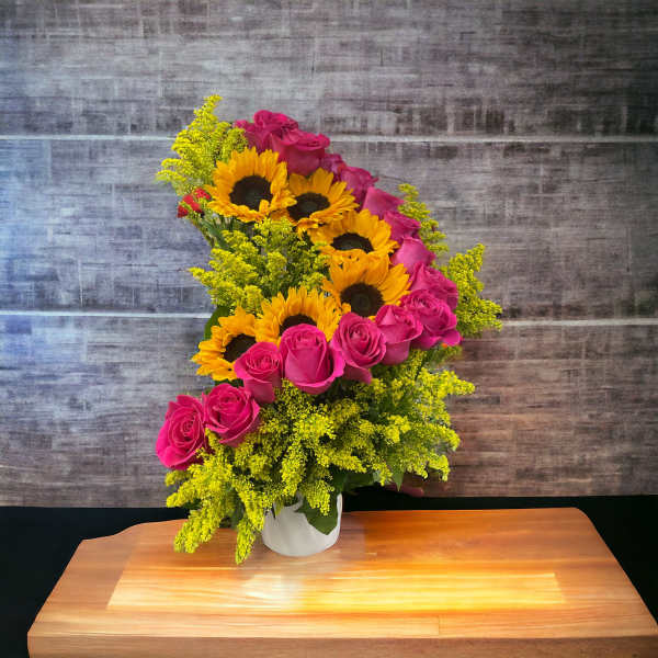 Pink roses and sunflowers in a white vase