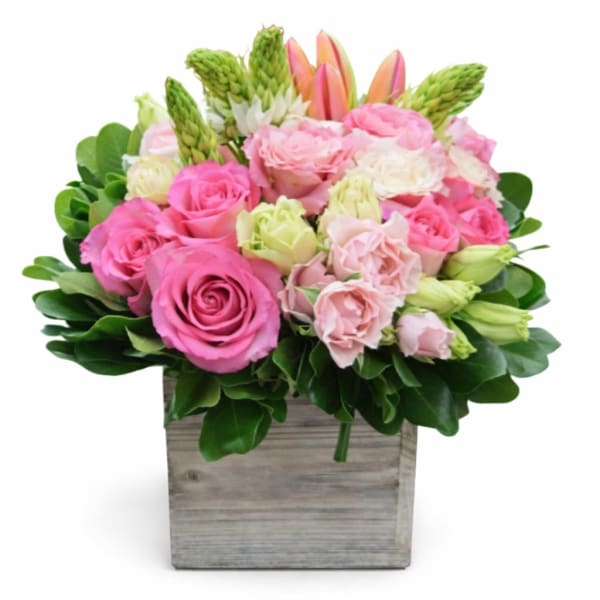 Pink roses and lisianthus in a wooden box