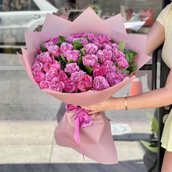 Large bouquet of pink roses wrapped in pink paper