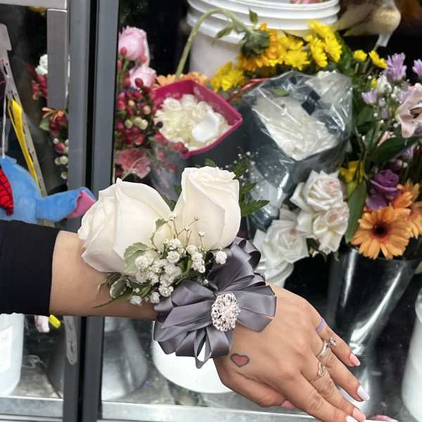 White rose wrist corsage with gray ribbon and small baby's breath