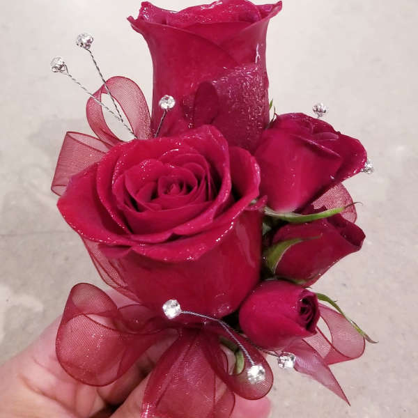 Handheld bouquet of deep pink roses with ribbon and crystal picks