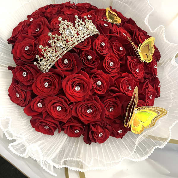 Red rose bouquet with a jeweled tiara and yellow butterfly decorations