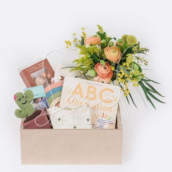 Gift box with flowers, books, and a crocheted cactus toy