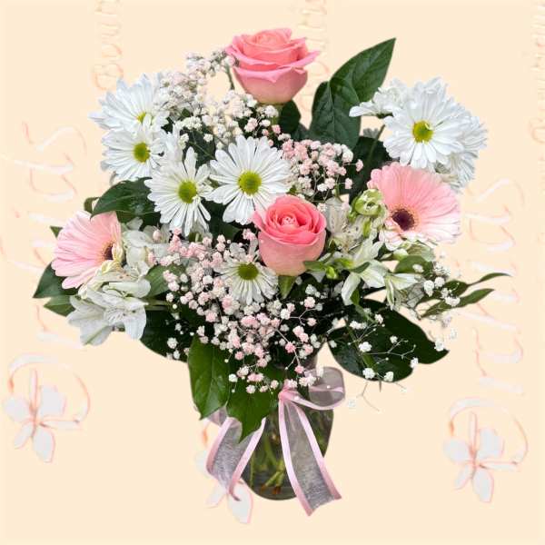 Pink roses and white daisies in a glass vase with a pink ribbon