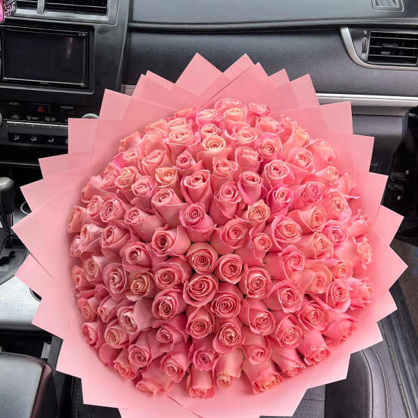 Large bouquet of pink roses wrapped in pink paper