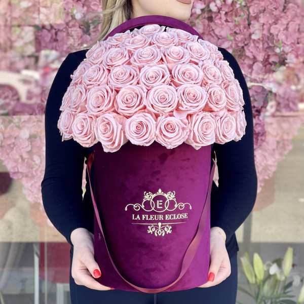 Large pink rose bouquet in a purple hatbox