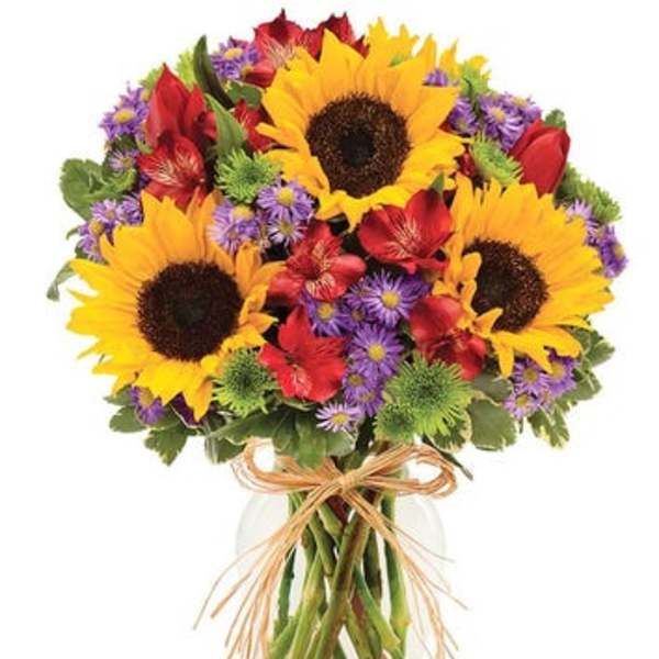 Bouquet of sunflowers, red flowers, and purple daisies in a glass vase