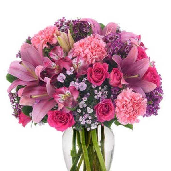 Pink and purple mixed bouquet in a clear glass vase