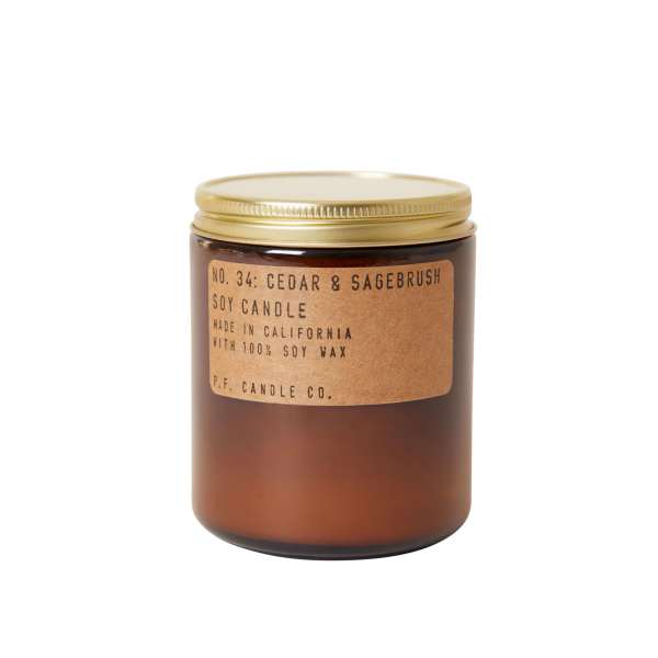 Brown glass candle jar with a gold lid and label