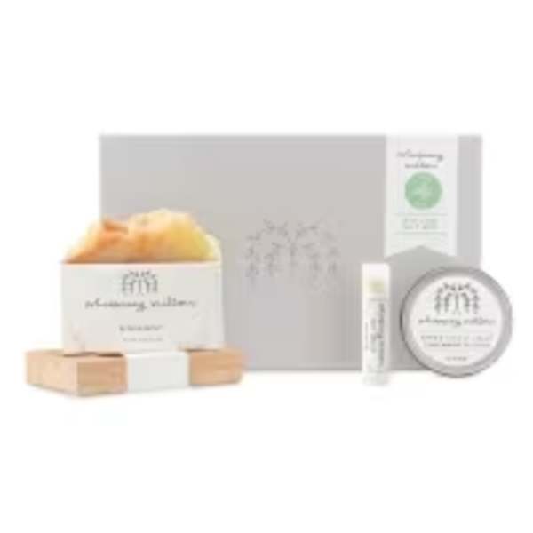 Gift set with soap, balm, and a candle in a gray box