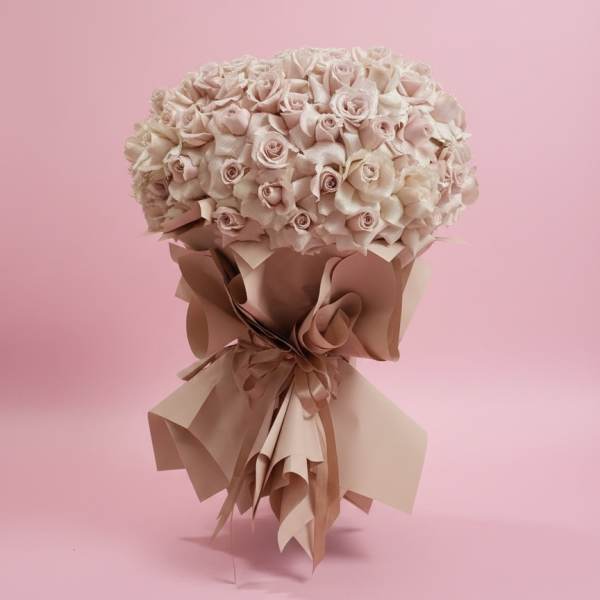 Bouquet of pale pink roses wrapped in blush paper