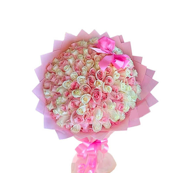 Large bouquet of pink and white roses wrapped in pink paper with a ribbon