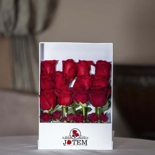 Box of red roses with a clear front window