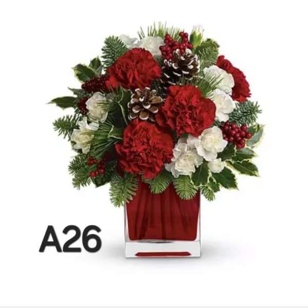 Red and white floral arrangement in a clear square vase