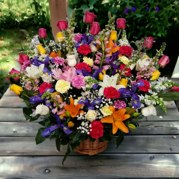 Colorful mixed flower basket with roses, lilies, and carnations