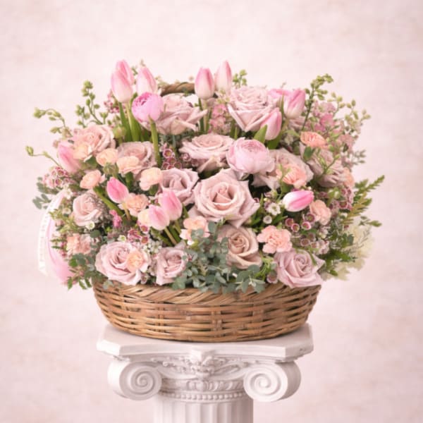 Pink roses and tulips arranged in a wicker basket