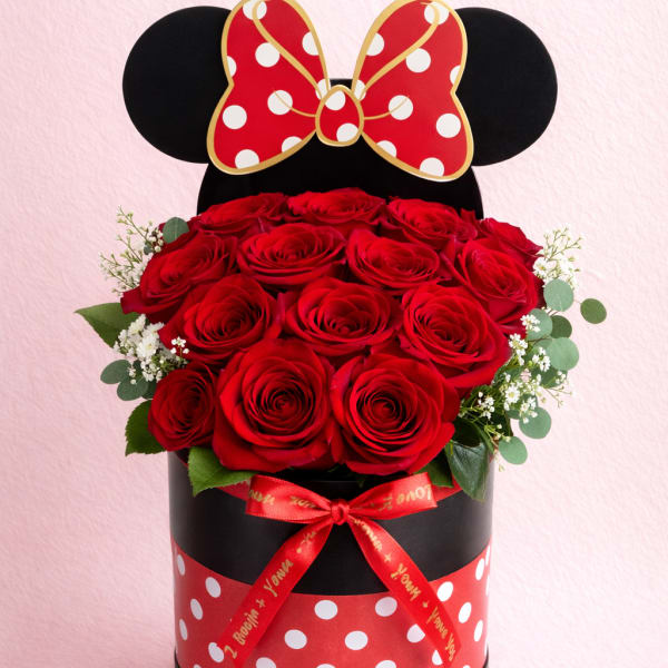 Red roses in a black round box with a Minnie Mouse bow topper
