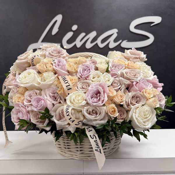 Basket of pastel roses with ribbon accents