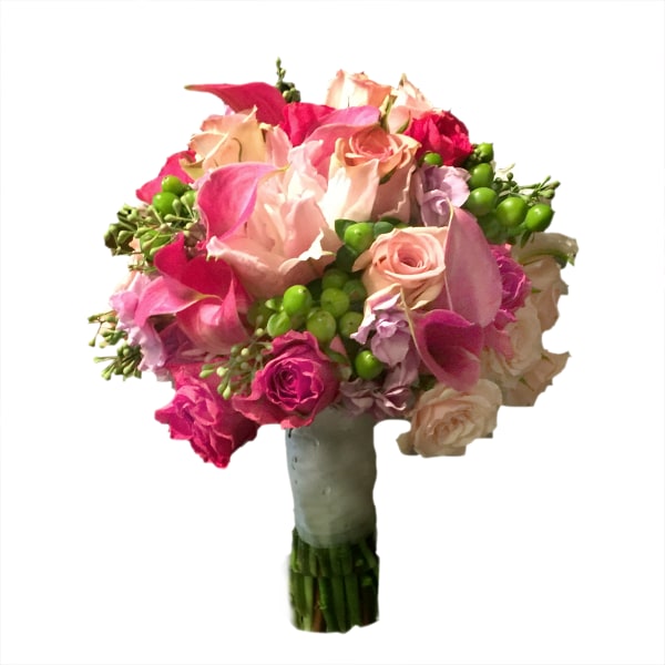 Bouquet of pink and peach roses with green berries in a wrapped handle