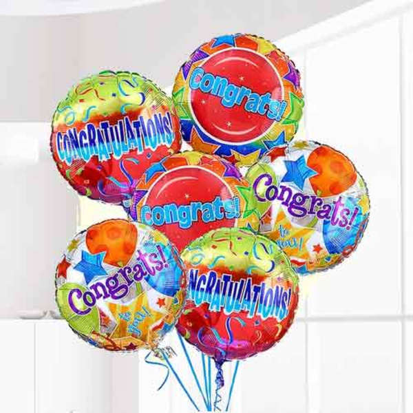 Cluster of colorful congratulatory balloons with star patterns