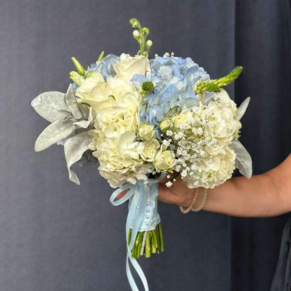 Blue and white bridal bouquet with roses and hydrangeas
