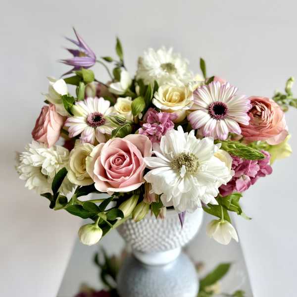 Pink and white mixed bouquet in a textured white vase