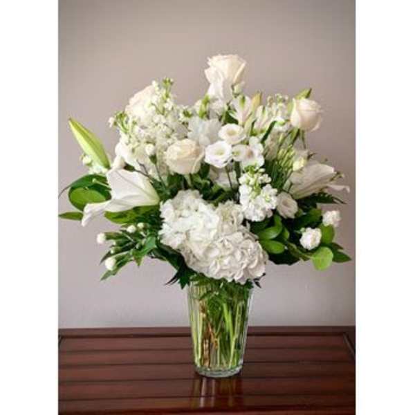 White floral arrangement in a clear glass vase