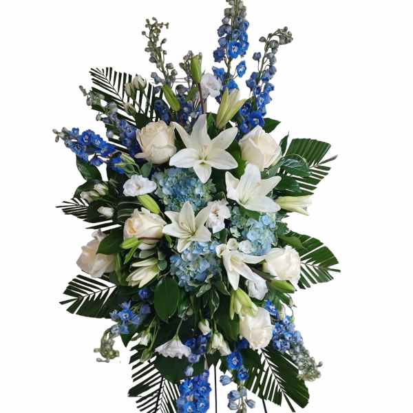 Tall white and blue floral standing spray with lilies and roses