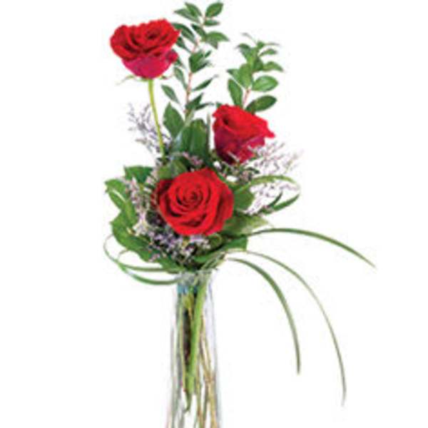Tall red rose arrangement in a clear glass vase