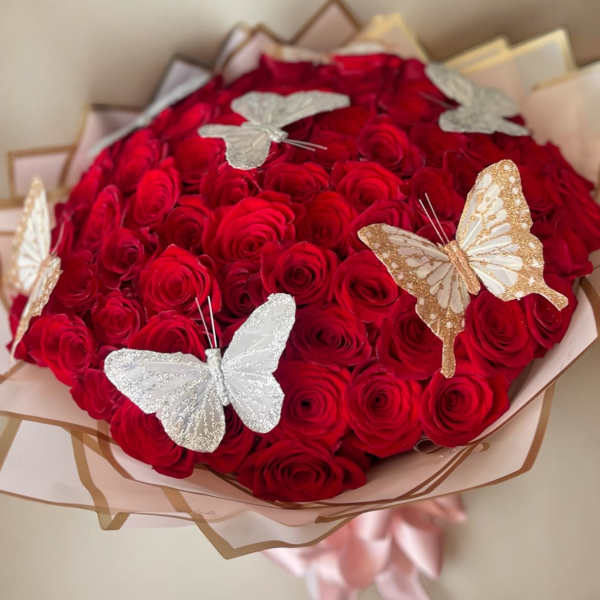 Bouquet of red roses with decorative butterfly accents