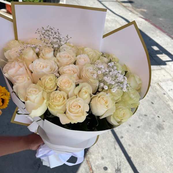 Bouquet of cream roses with baby's breath in white wrap