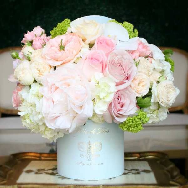 Pastel pink and white rose arrangement in a white hat box