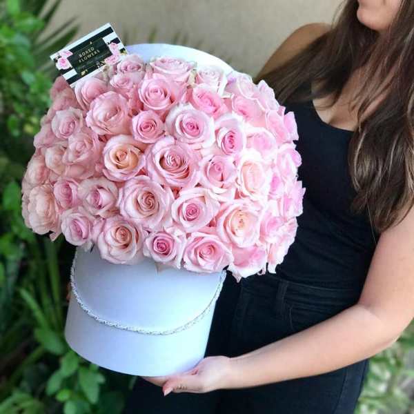 Large bouquet of pink roses in a white hat box
