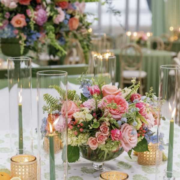 Low floral centerpiece with pink and peach roses in a glass bowl