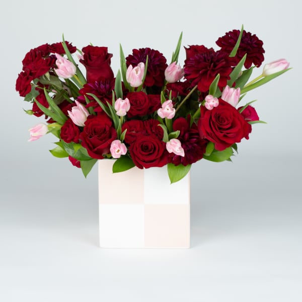 Red roses and pink tulips in a white box
