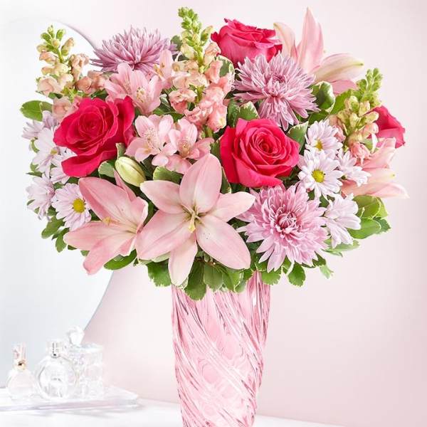 Pink and white mixed bouquet in a pink glass vase
