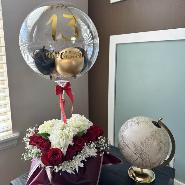 Red roses and white hydrangeas with a clear anniversary balloon