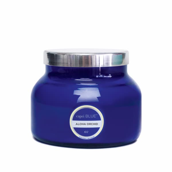 Blue glass candle jar with a silver lid and label