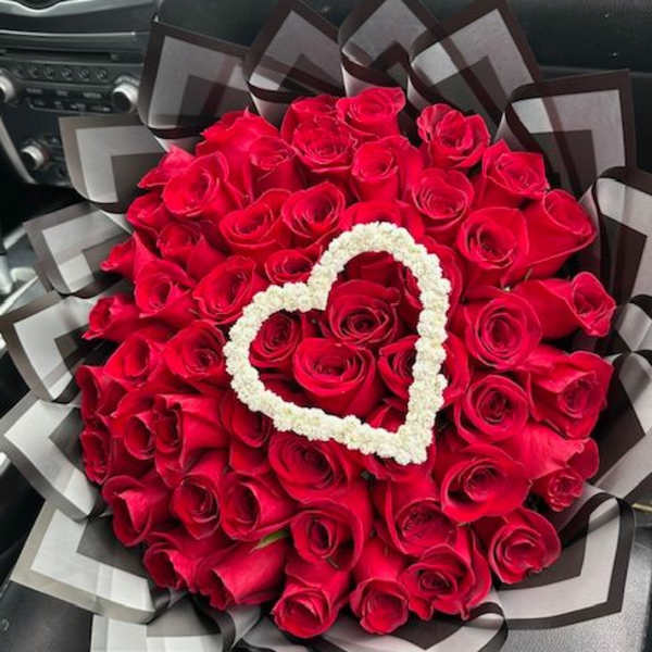 Bouquet of red roses with a white heart accent and black-gray wrap