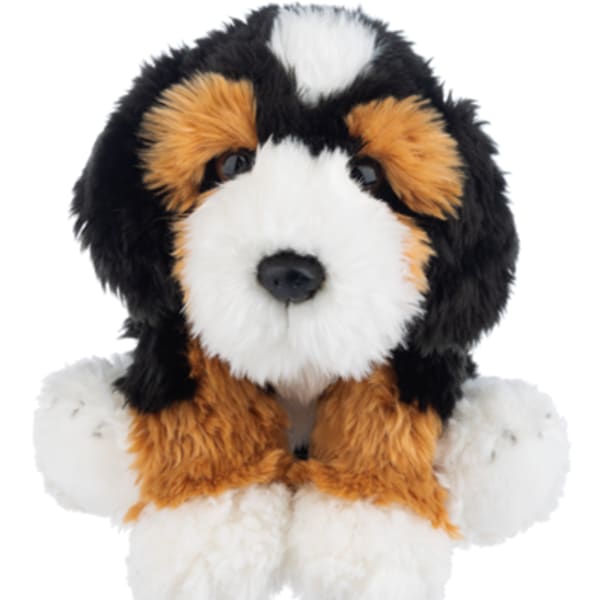 Plush dog toy with black, white, and tan fur