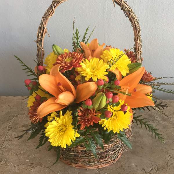 Basket arrangement with orange lilies and yellow chrysanthemums